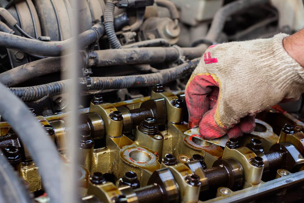 mechanic working on engine, head gasket