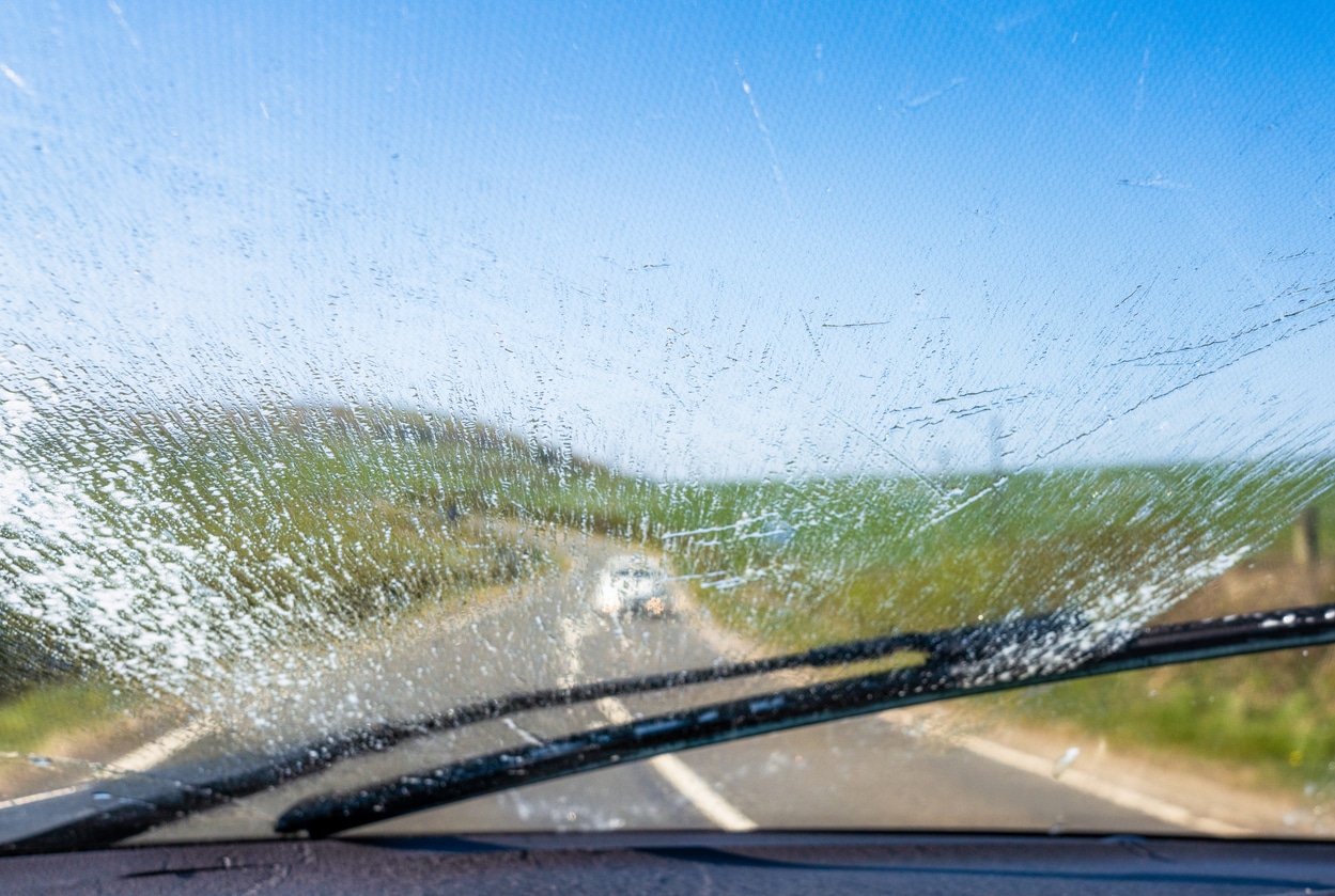 Cleaning the windscreen on country drive